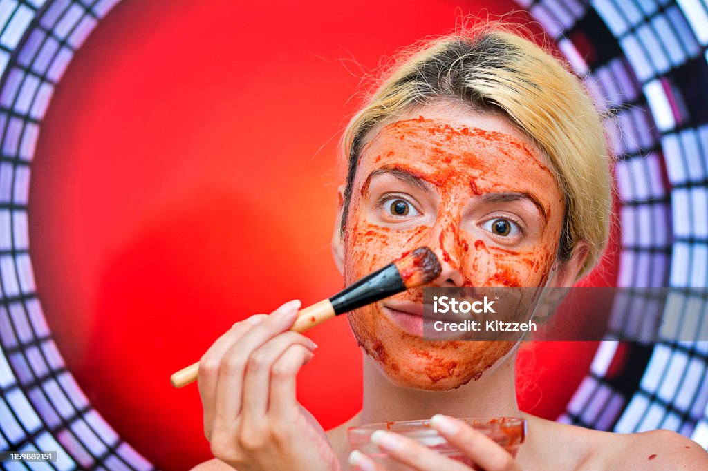 girl applying tomato face mask for nourishing her skin