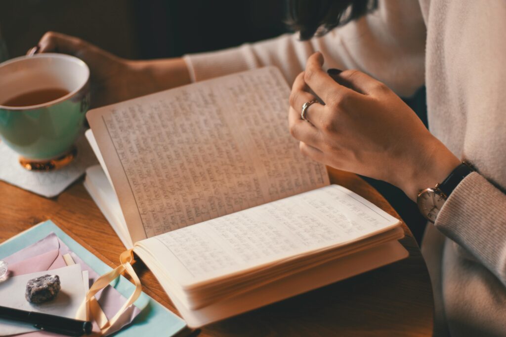 girl reading positive affirmation in notebook