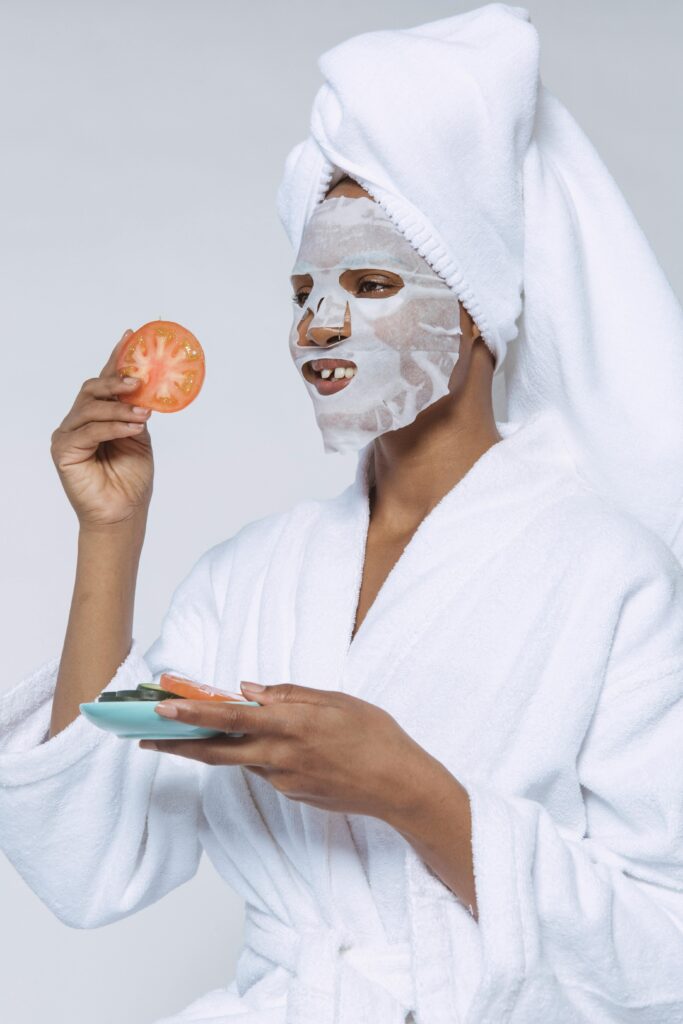 girl doing her skincare using tomato.