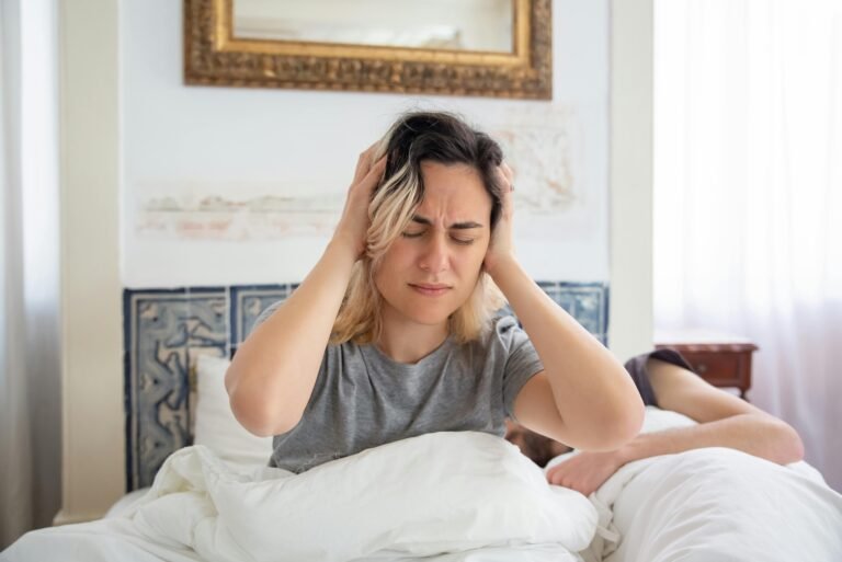 girl sitting stressed on bed. image source: pexels