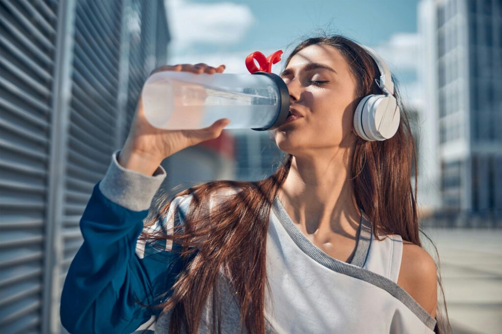 girl staying hydrated. image source: pexels