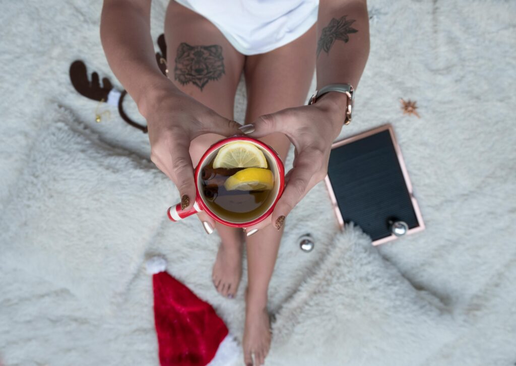 girl holding cup of tea for hydration in winter. image source-pexel